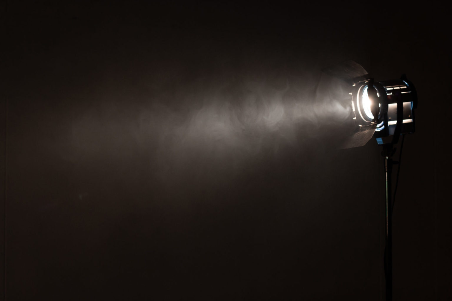 Studio spotlight using for background production film . silhouette blurred led lights with smoke in dark room . electric tools set for photography , video maker , cinematography